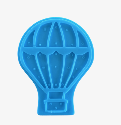Bar of soap with hot air balloon design by Plunk Soap Company, perfect as gifts or party favors with a travel theme.